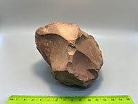 an orange/brown smooth rock with concoidal surface fracture, no visible crystals.